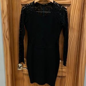 Parker body con, mini dress lace back is Shear down to waist line full sleeve